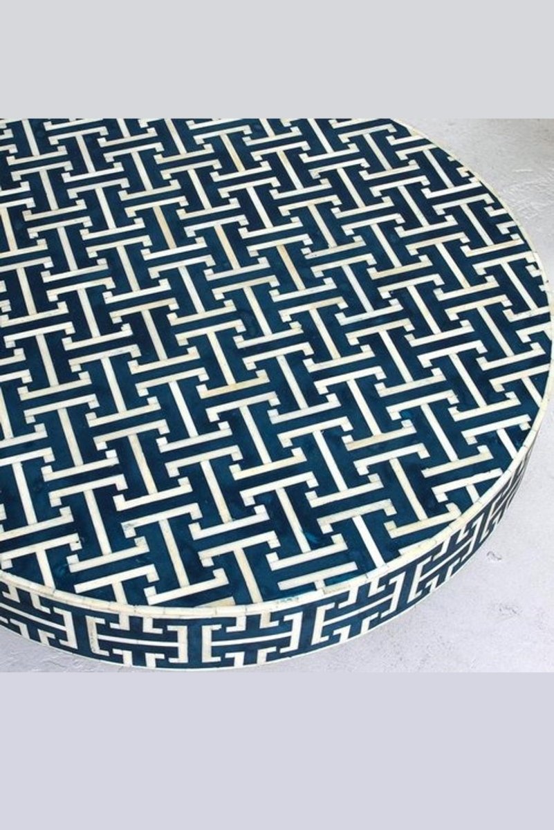 Handmade blue bone inlay accent table shown from a slightly elevated front angle, highlighting the round patterned tabletop, white geometric inlay lines, and cylindrical brass base in a complete furniture product view.