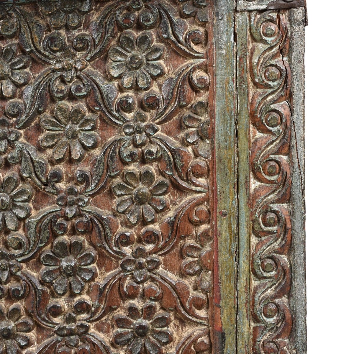 Vine carved trunk chest in solid wood, edge detail view showing a floral panel beside a narrow scrolling vine border.