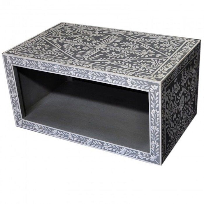 Bone inlay living room coffee table in charcoal grey with intricate white floral inlay across the top and all sides, open storage shelf below, handcrafted from solid mango wood