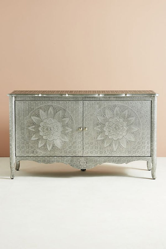 Hand-embossed silver metal buffet credenza featuring two doors with large lotus flower medallions on elegant curved cabriole legs.