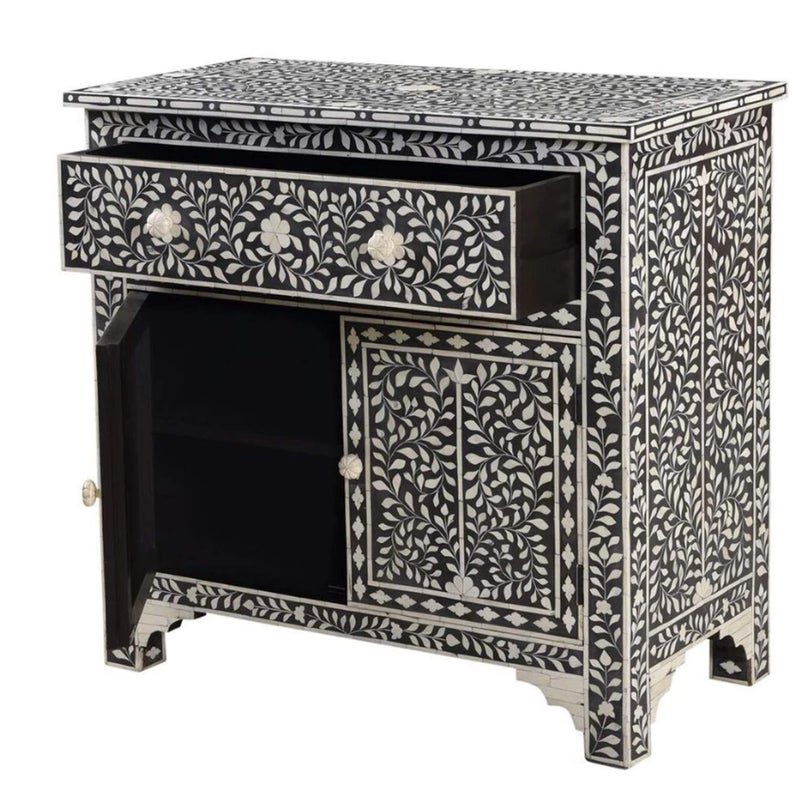 Black bone inlay cabinet with open top drawer and open left door revealing interior shelving, intricate ivory floral vine inlay on charcoal base