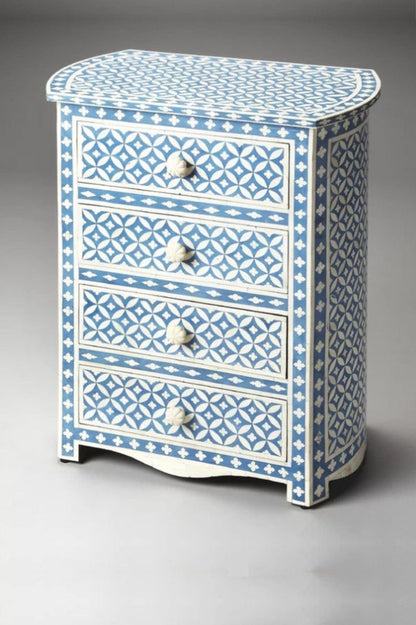 Three-quarter view of the Handmade Bone Inlay Geometric Eye Pattern Nightstand | Lampstand in Blue Color, featuring four pull-out drawers with carved bone knobs and all-over blue geometric inlay on mango wood.