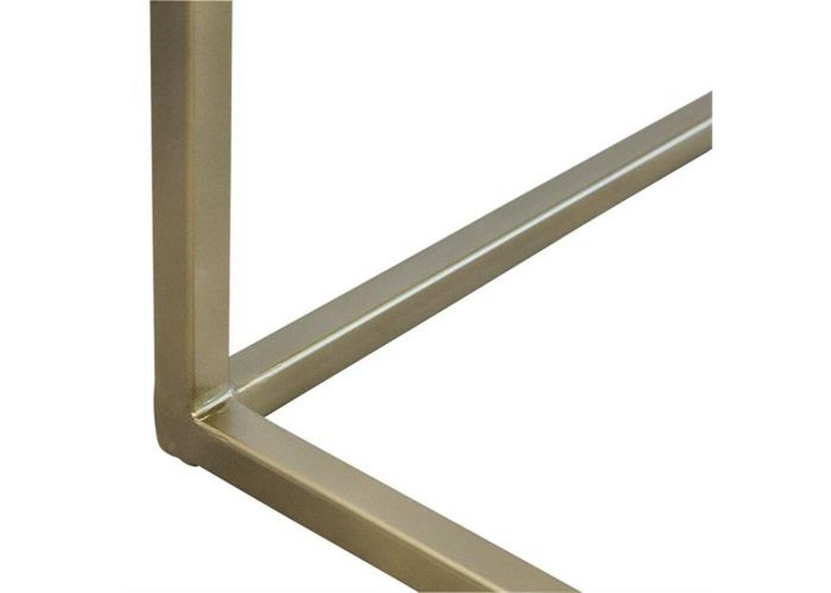 Brass metal open-frame base of a bone inlay bar cabinet showing precision welded corner joints with a clean satin gold finish