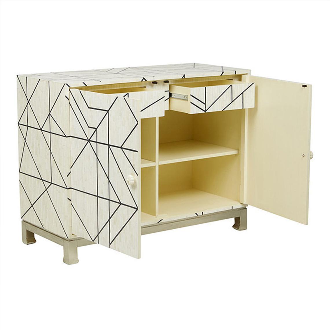 Open bone inlay cabinet revealing cream interior with adjustable shelf and drawer, ivory geometric mosaic exterior with black line inlay detailing