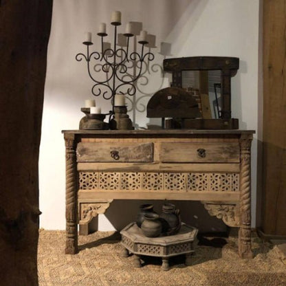 Handcrafted reclaimed solid wood credenza with intricate lattice carvings, two drawers, and twisted leg detailing in a rustic, curated home entryway.
