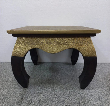 Traditional square accent stool table featuring a gold-finished top and an embossed gold metal floral apron on dark curved cabriole legs.