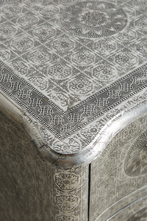 102 cm wide silver embossed dresser with four drawers, a solid wood structure, and an elegant scalloped base.